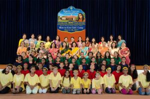 Volunteers and girls come together for a group photo.