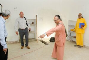 Swami Ishwarananda discusses the layout of the printing press room.