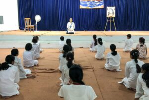 A volunteer conducts yogasana class daily.