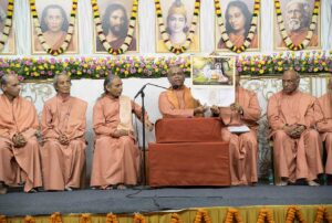 Swamiji displays the 2019 YSS calendar.