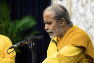 Brahmachari Achyutananda chants during prasad distribution.