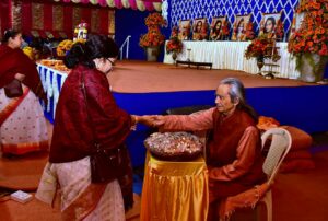 Swami Nirvanananda distributes prasad.