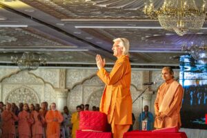 Swami Chidananda pranams to devotees after his talk.