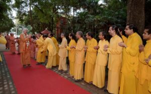 Monks shower flowers at Swamijiâ€™s feet as he pranams.